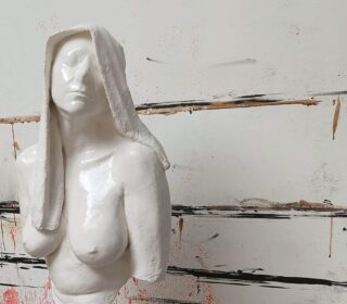 An image showing a woman's bust and veiled head