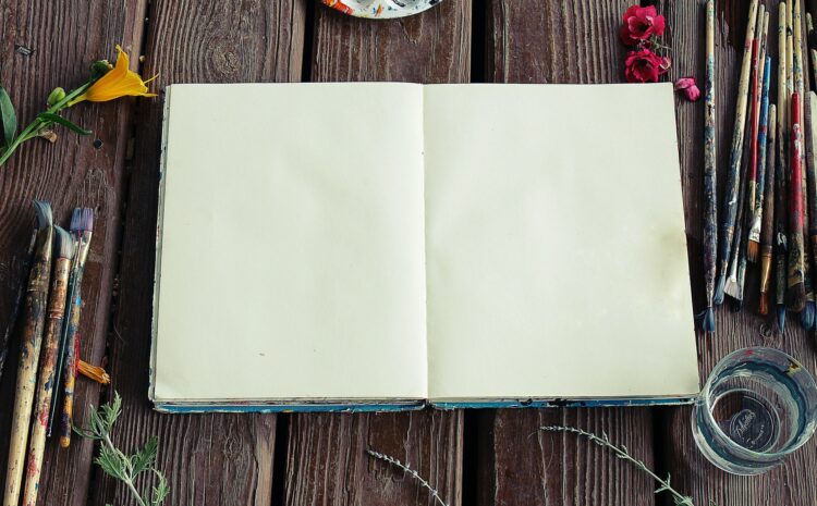 A photo showing a blank sketchbook and a background of flowers