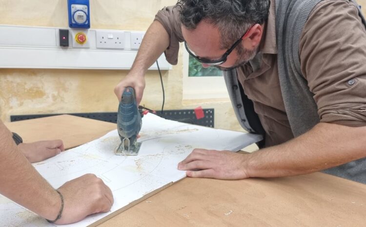 An image of a person using a jigsaw to cut wood