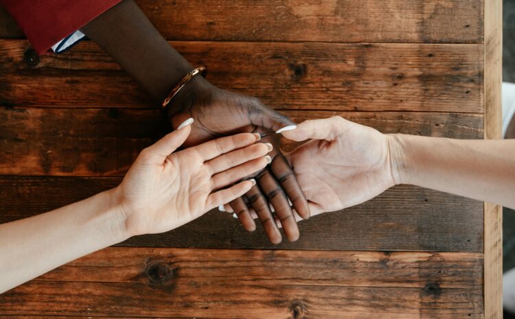 A photo showing the palms of three people of different ethnicities