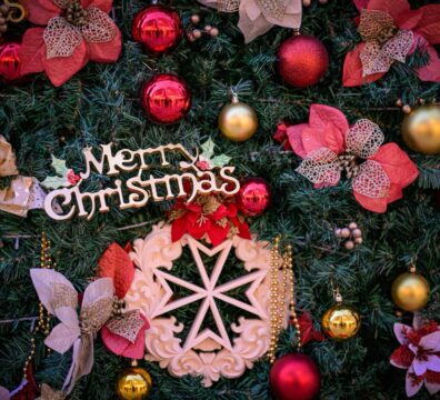 A photo showing a detail of the Valletta national Christmas Tree with a Maltese Cross ornament with the text Merry Christmas