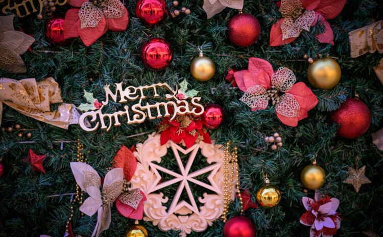A photo showing a detail of the Valletta national Christmas Tree with a Maltese Cross ornament with the text Merry Christmas