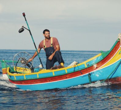 A still from the film Luzzu showing a fisherman on the traditional Maltese Luzzu