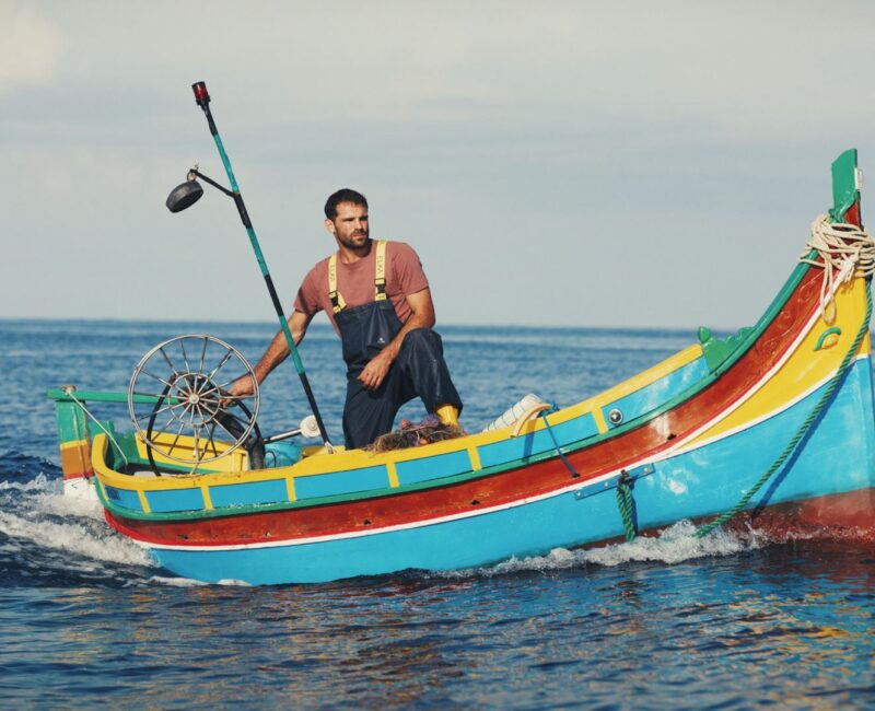 A still from the film Luzzu showing a fisherman on the traditional Maltese Luzzu