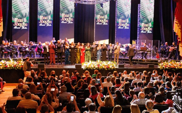 A photo showing singers on stage and the audience during the 2025 concert Ilħna li Jibqgħu