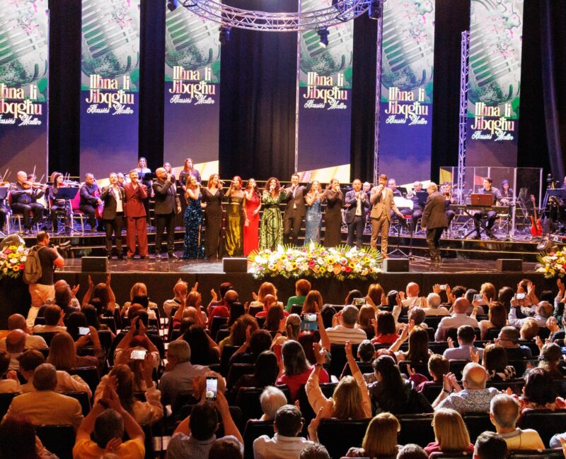 A photo showing singers on stage and the audience during the 2025 concert Ilħna li Jibqgħu