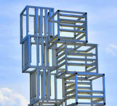 A detail from a geommetrical public artwork agaisnt a blue sky